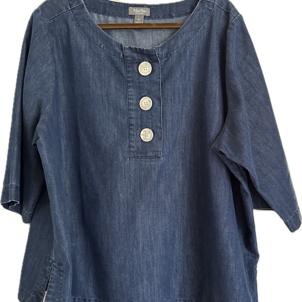 Denim cropped top with white buttons.
